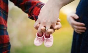 Hand Holds Hands Pink Baby Shoes