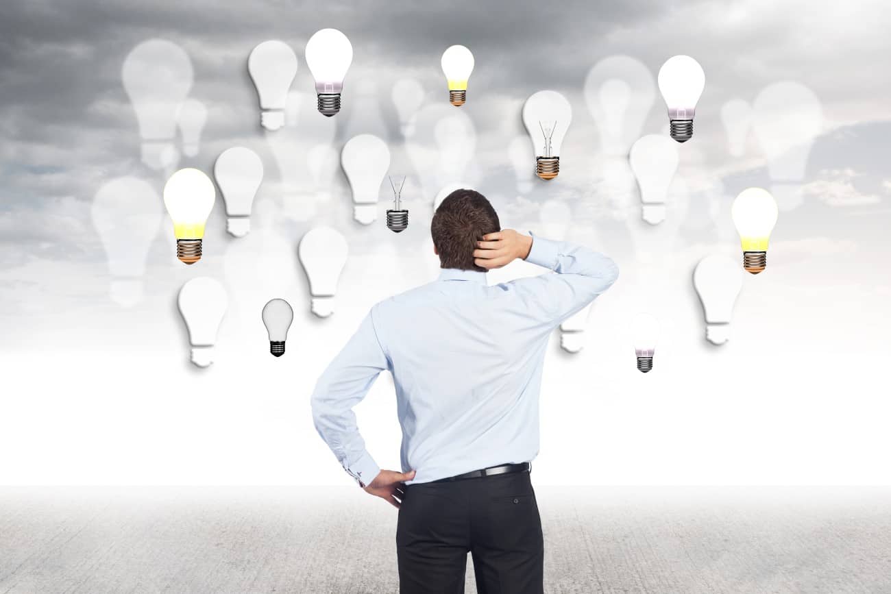Man touching his head and looking bulbs