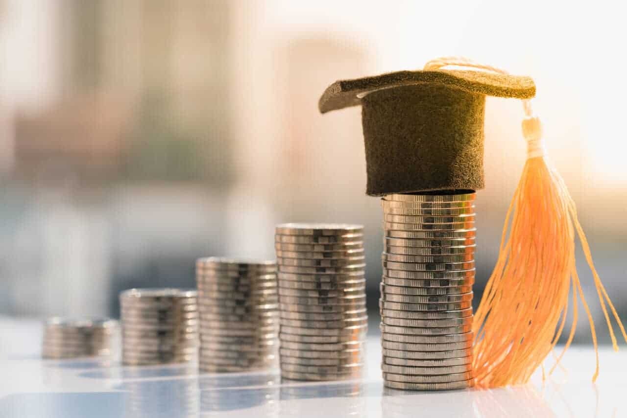 Graduation hat on top coin stack