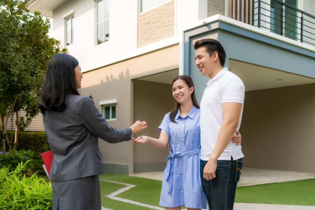 Happy asian couple buying a new house